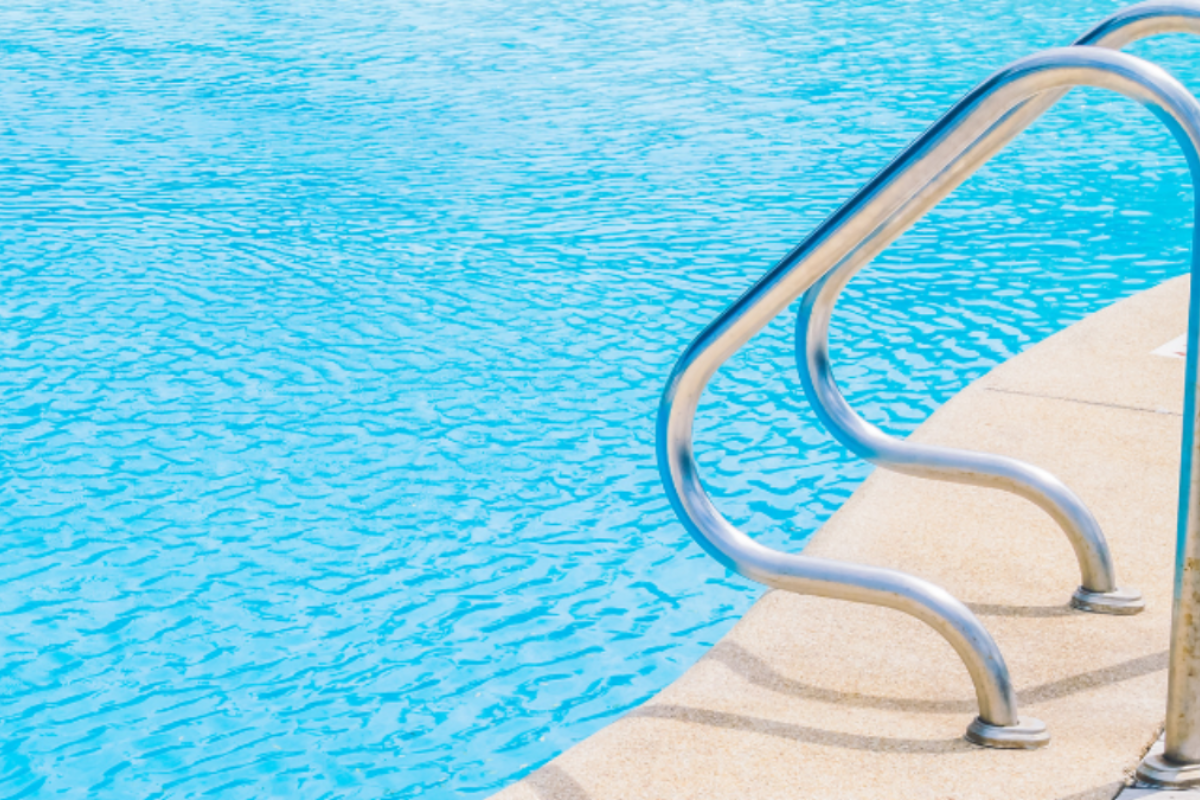 a metal ladder for an outdoor in-ground pool.