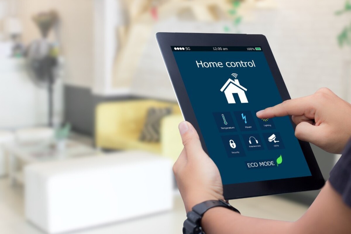 A person using a smart tablet to manage his home's energy use efficiently.