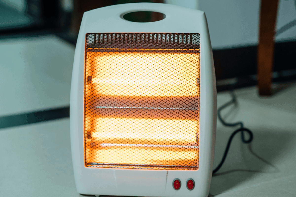 a space heater plugged in inside of a home. Space heaters are one of the top 5 appliances that use the most energy.