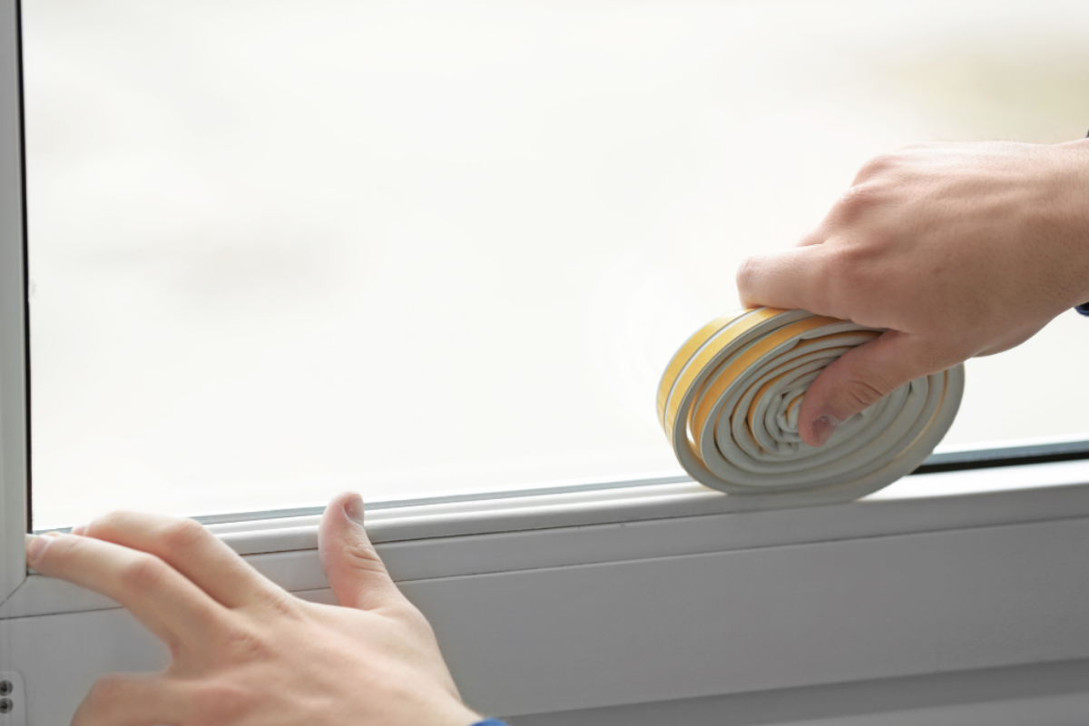 weatherstripping being applied to a window