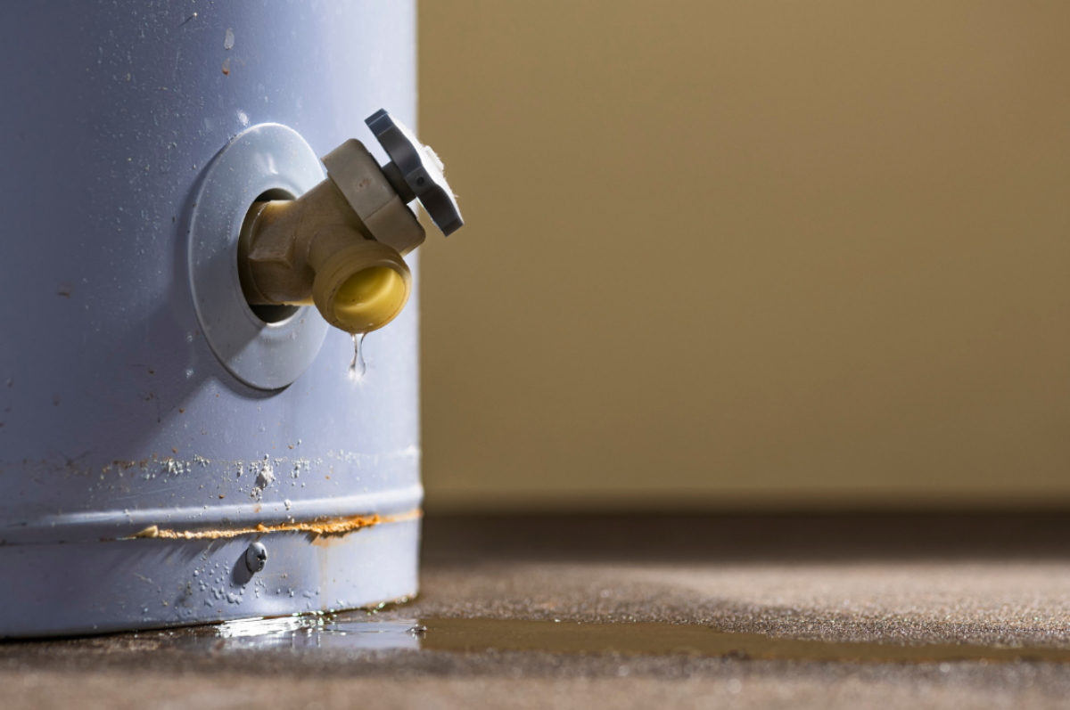 a water heater leaking from its faucet. This is a sign that the water heater might need to be replaced.