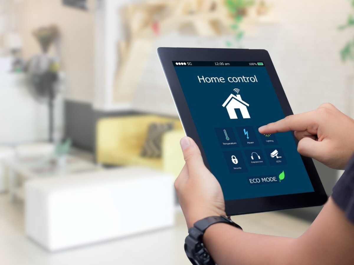 A person using a smart tablet to manage his home's energy use efficiently.