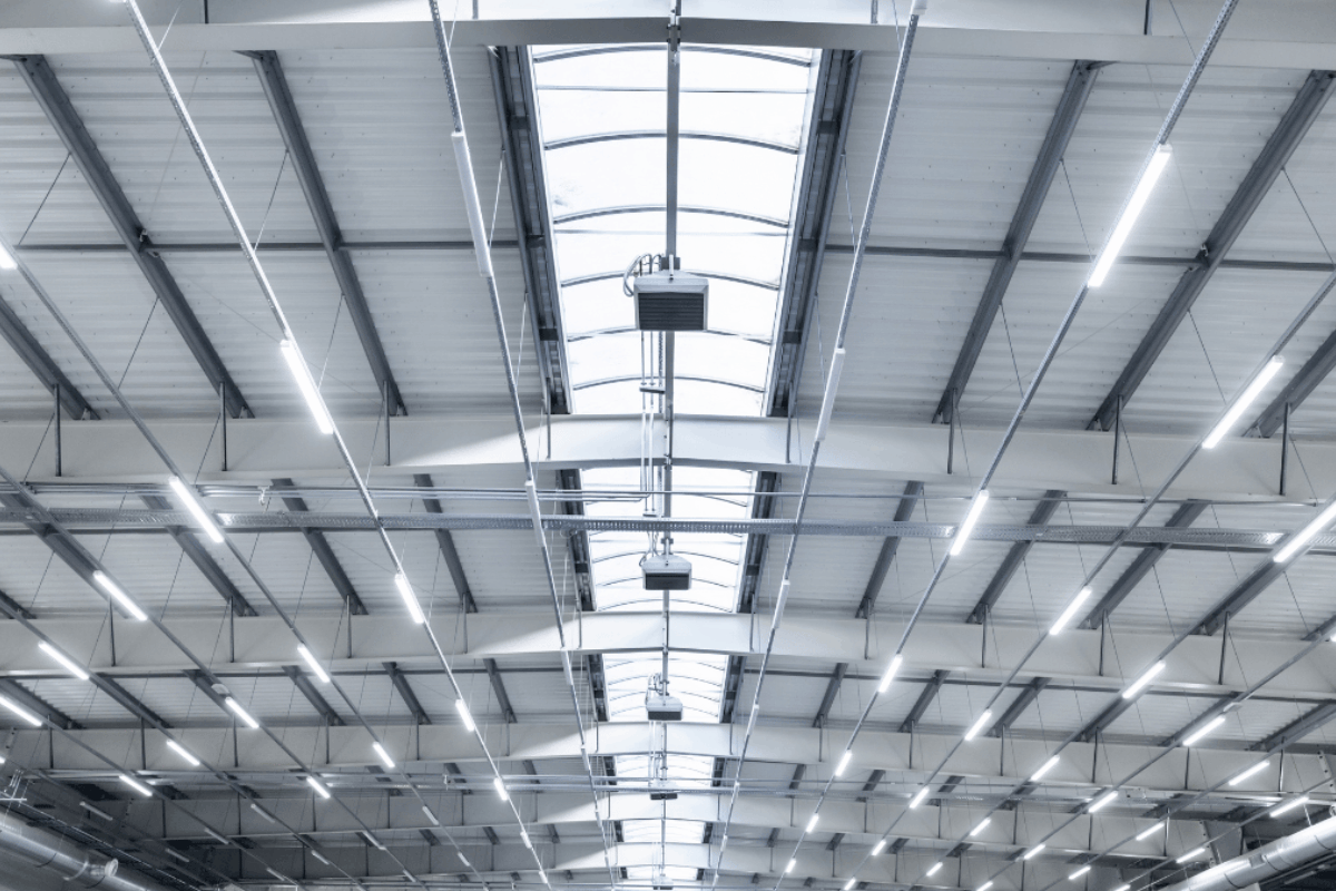 the ceiling of a warehouse that uses energy efficient led light fixtures.