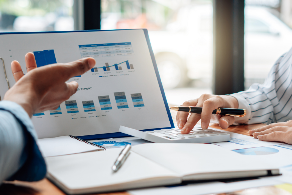 Two individuals reviewing charts detailing energy use data