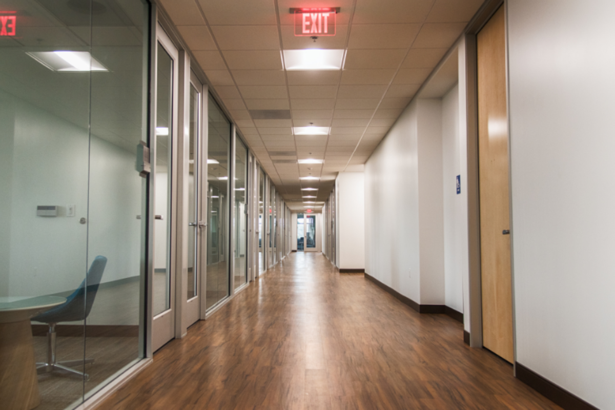 the hallway of an office building. Improving the energy efficiency in an office can increase employee comfort and safety.
