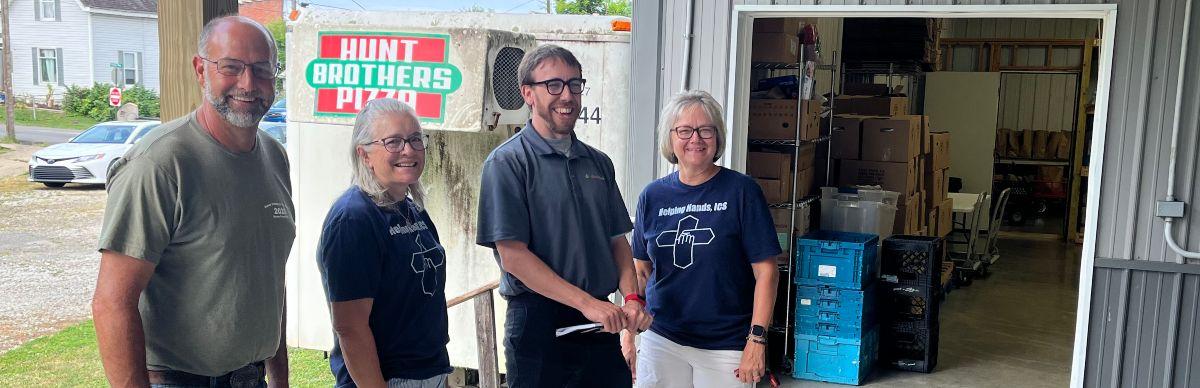 Helping Hands and Efficiency Smart staff outside the Helping Hands facility