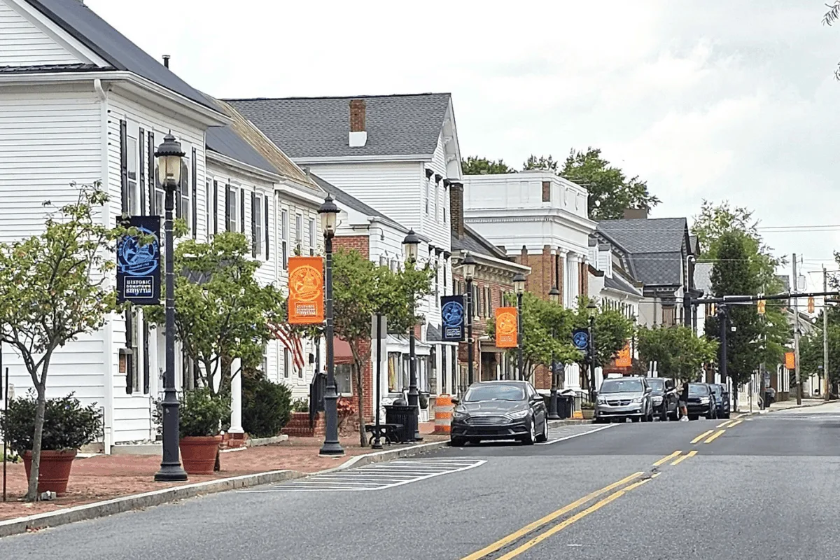 a street in downtown Smyrna, Delaware with cars parked along the street.
