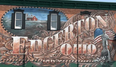 a detailed painting on the side of a building that says, "Edgerton, Ohio".