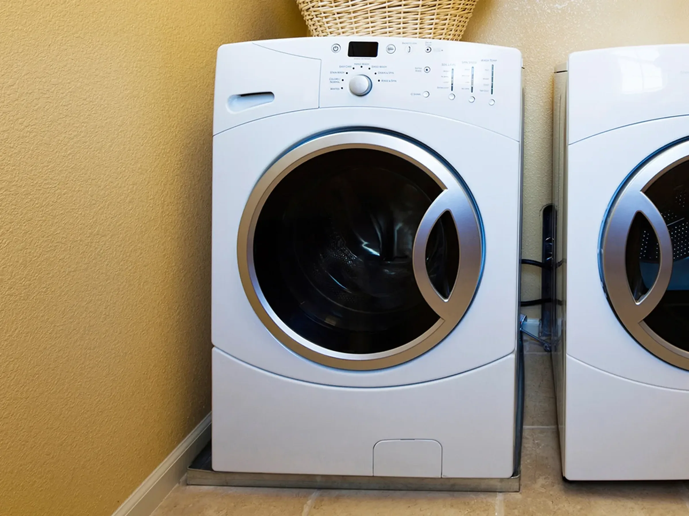 a clothes washing machine next to a matching electric clothes dryer unit.