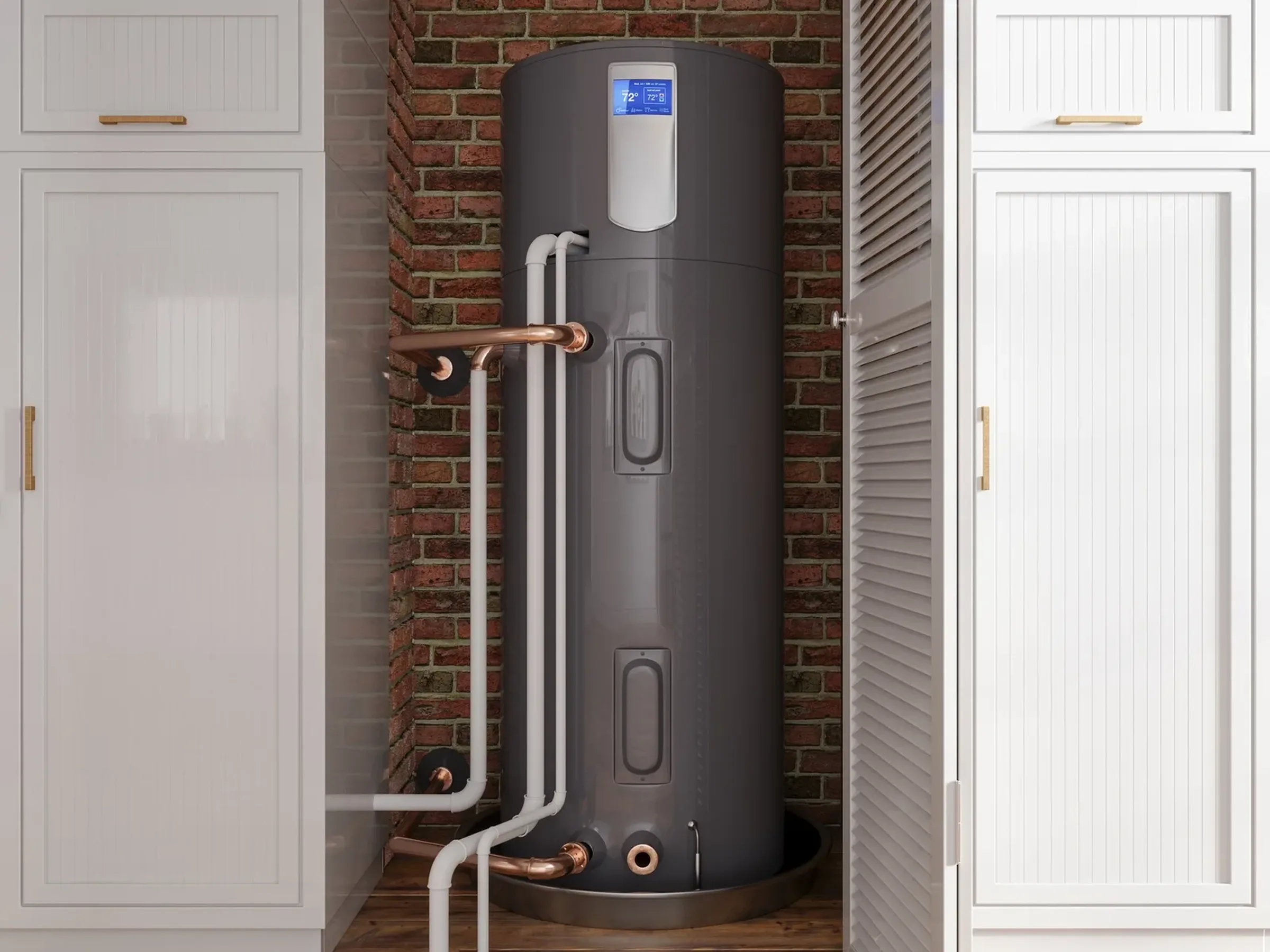 a heat pump water heater installed in-between two cabinets in a home.