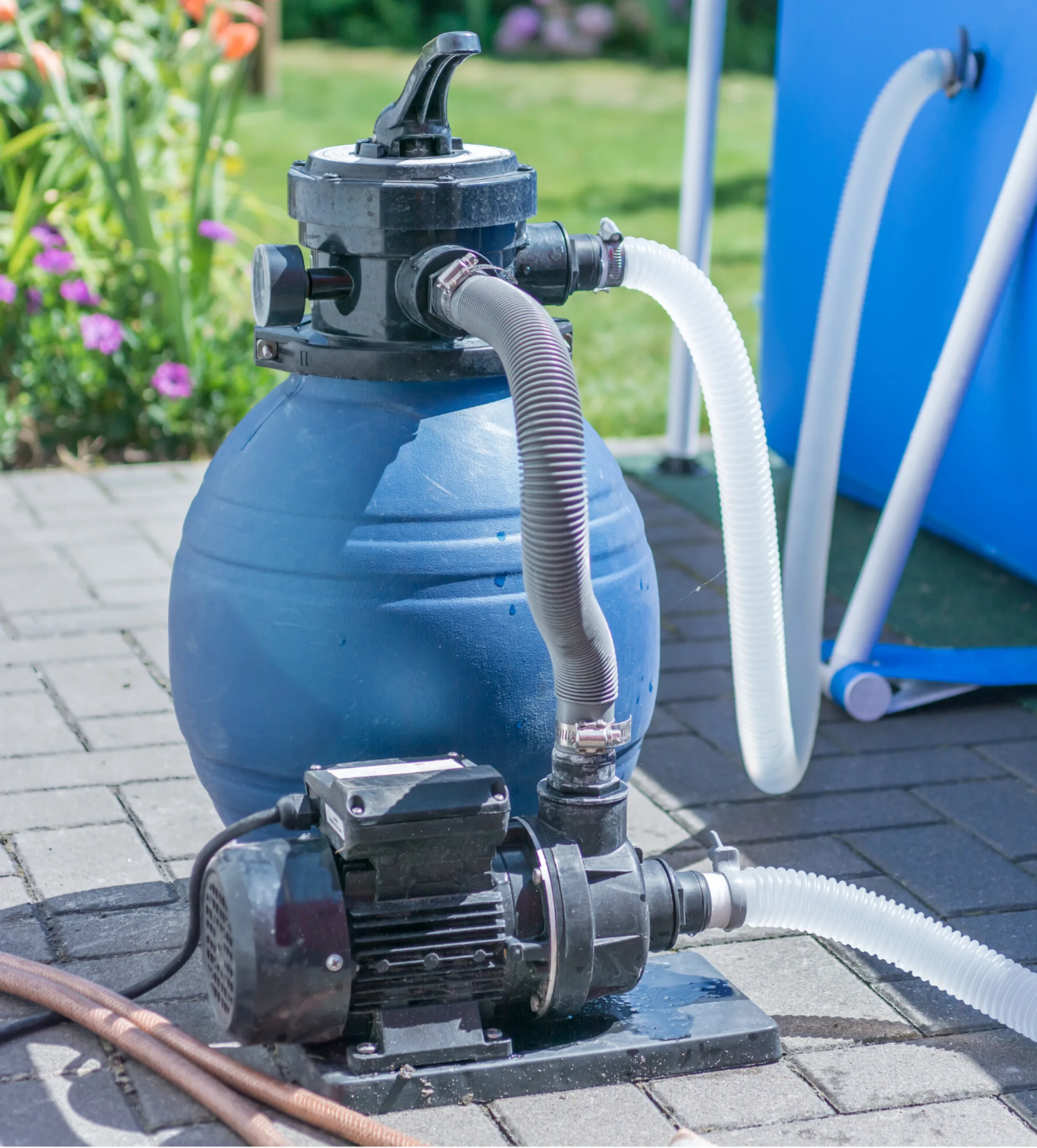 an above-ground pool pump attached to an outdoor pool.